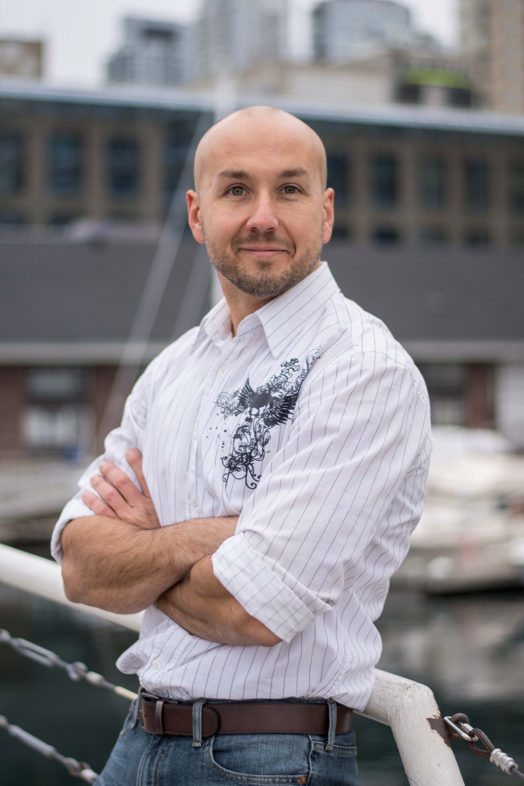 Client session photo: man in a white shirt with arms crossed at the Harbourfront marina