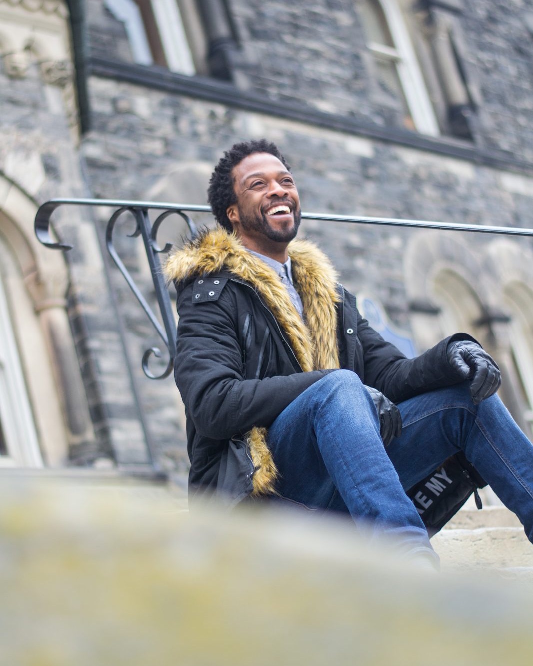 Tinder Photography client laughing on stone steps during a dating profile photoshoot in Toronto